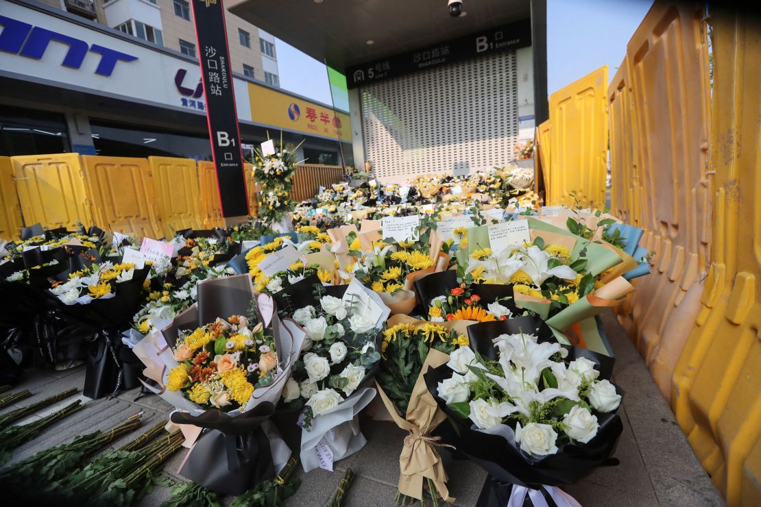 Flowers are placed as tributes in front of Shakou Road subway station in memory of flood victims in Zhengzhou.