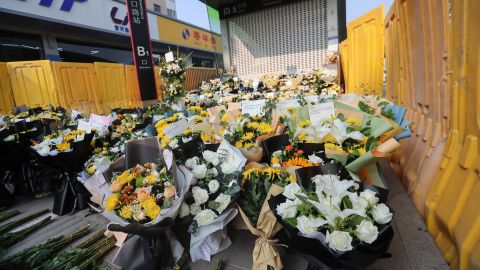 Flowers are placed as tributes in front of Shakou Road subway station in memory of flood victims in Zhengzhou.
