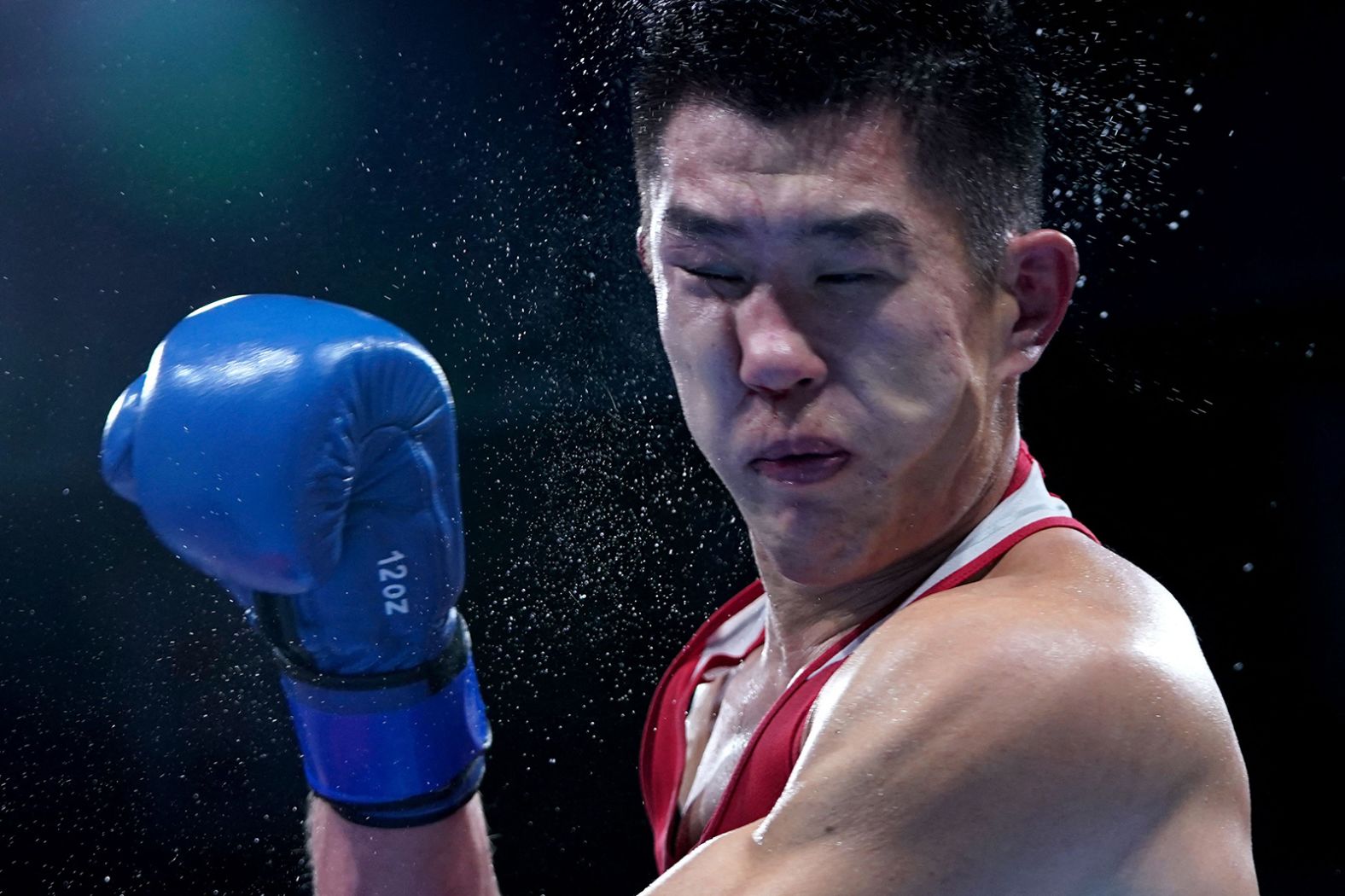 Kazakhstan's Bekzad Nurdauletov gets hit by Russian boxer Imam Khataev during their light-heavyweight match on July 28. Khataev won 4-1.