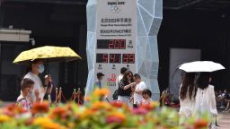 BEIJING, CHINA - 2021/07/19: People wearing face masks walk past the countdown clock showing 200 days to the 2022 Olympic Winter Games.
2022 Beijing Winter Olympic Games are planned to be held on February 4, 2022. The 200 days countdown begins today. (Photo by Sheldon Cooper/SOPA Images/LightRocket via Getty Images)