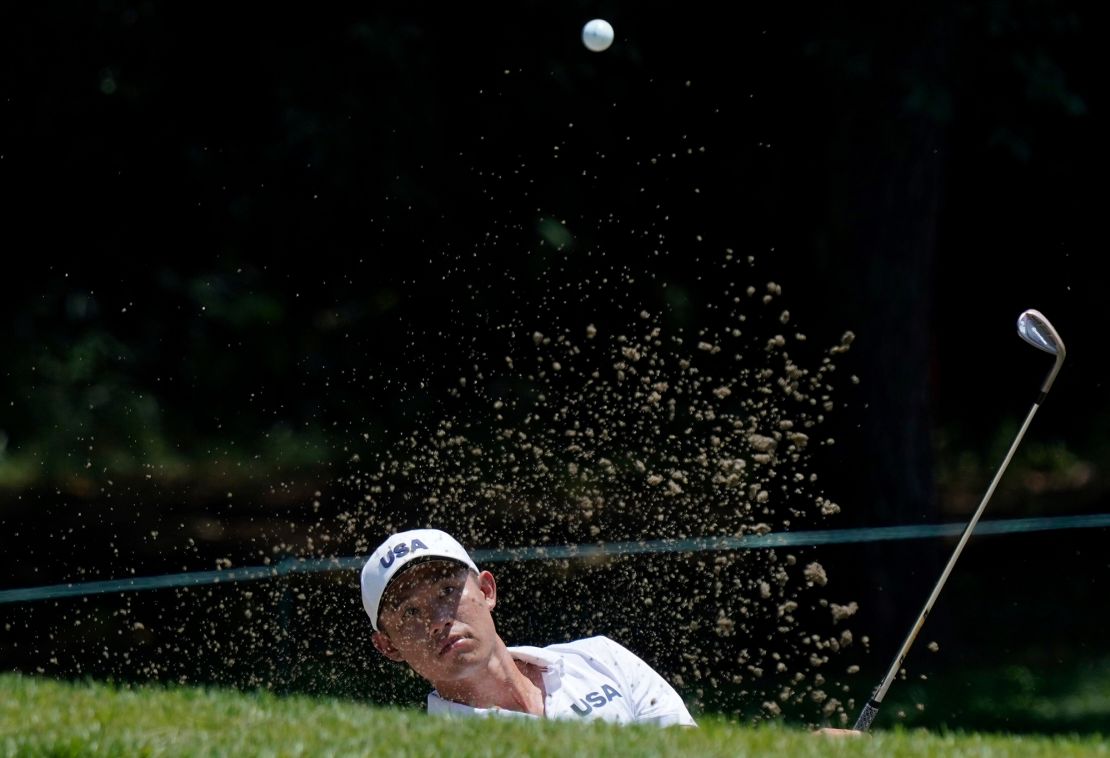 Morikawa plays a shot from a bunker during a practice round of the men's golf event at the 2020 Summer Olympics.