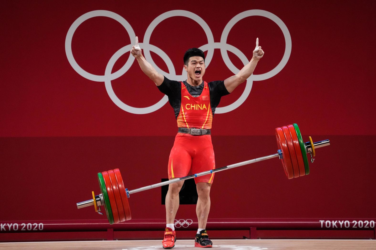 Chinese weightlifter Shi Zhiyong celebrates July 28 after winning gold in the 73-kilogram weight class. He lifted 166 kilograms in the snatch and 198 kilograms in the clean-and-jerk, setting <a href="index.php?page=&url=https%3A%2F%2Fwww.cnn.com%2Fworld%2Flive-news%2Ftokyo-2020-olympics-07-28-21-spt%2Fh_377e9649c19957df713a660d039f1d4e" target="_blank">a new world record total of 364 kilograms.</a>