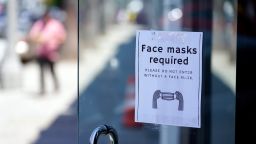 A sign advises shoppers to wear masks outside of a story Monday, July 19, 2021, in the Fairfax district of Los Angeles. Los Angeles County has reinstated an indoor mask mandate due to rising COVID-19 cases. (AP Photo/Marcio Jose Sanchez)
