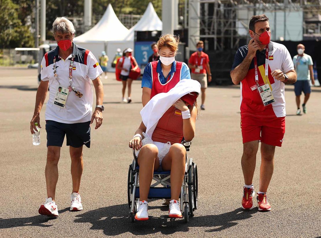 Paula Badosa of Spain is helped away from the court in a wheelchair after having to retire from her quarterfinal match against Marketa Vondrousova.
