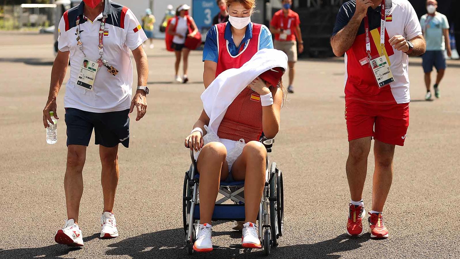 Paula Badosa of Spain is helped away from the court in a wheelchair after having to retire from her quarterfinal match against Marketa Vondrousova.