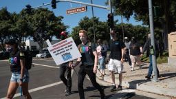 Employees walk across Blizzard Way during a walkout at Activision Blizzard offices in Irvine, California, U.S., on Wednesday, July 28, 2021. Activision Blizzard Inc. employees called for the walkout on Wednesday to protest the company's responses to a recent sexual discrimination lawsuit and demanding more equitable treatment for underrepresented staff. 