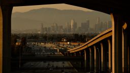 Vehicles drive on the 110 Freeway towards the Los Angeles skyline at the Judge Harry Pregerson Interchange during rush hour traffic in Los Angeles, California on July 16, 2021. 