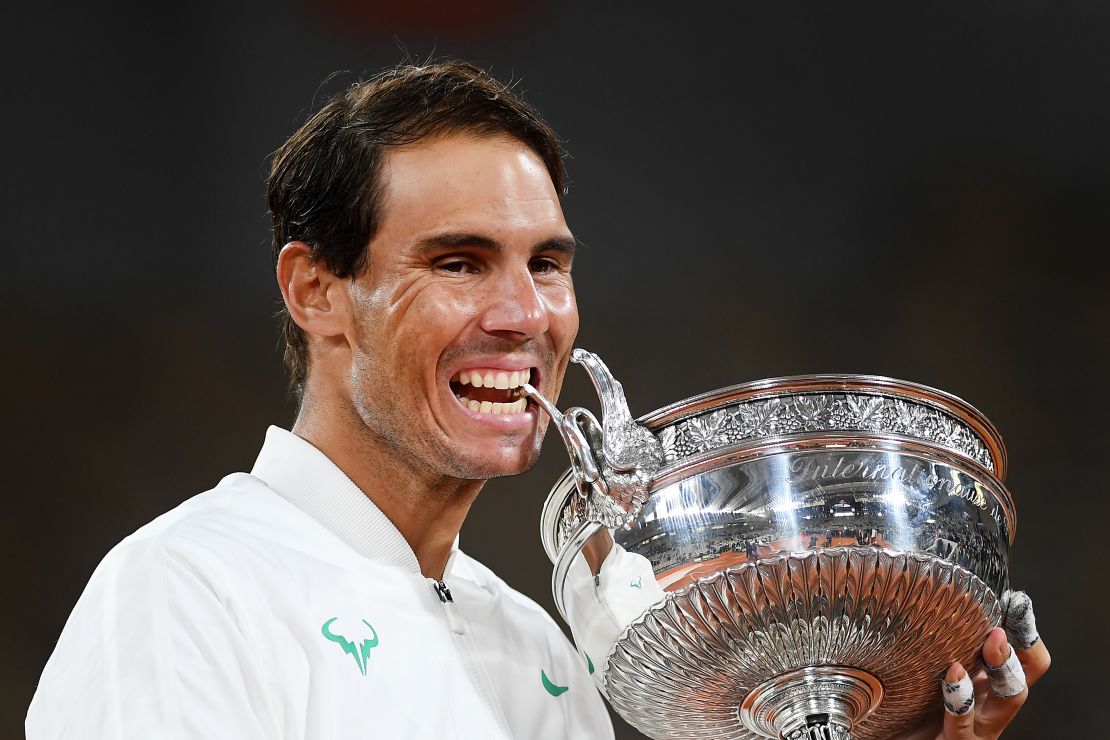 Nadal bites the Coupe des Mousquetaires following victory at the French Open. 