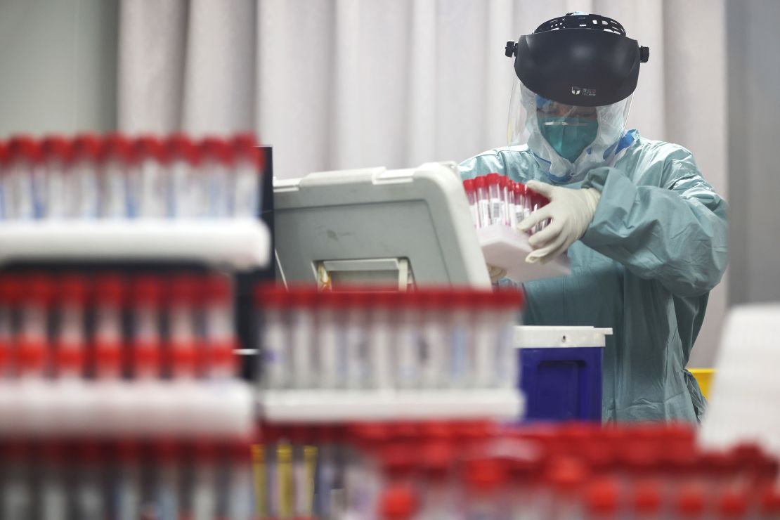 A medical worker works on samples from local residents to be tested for Covid-19 at a laboratory in Nanjing, China, on July 24.