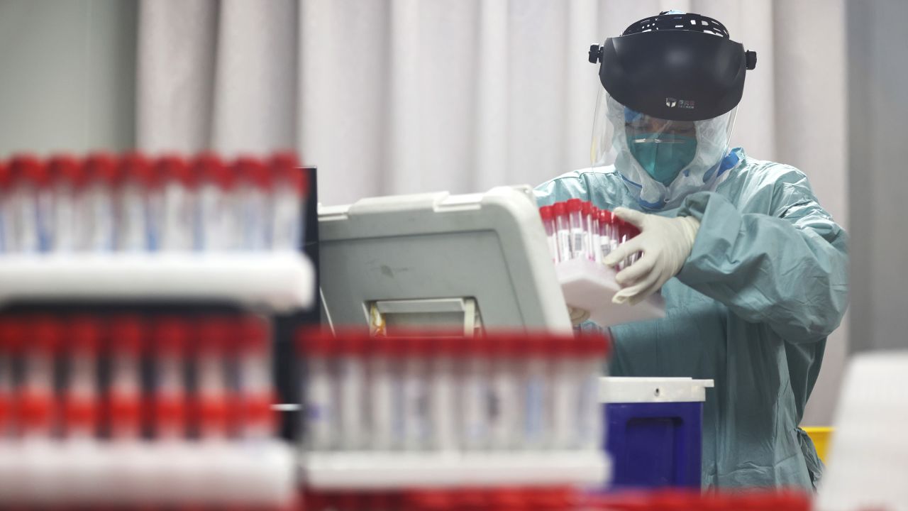 A medical worker works on samples from local residents to be tested for Covid-19 at a laboratory in Nanjing, China, on July 24.