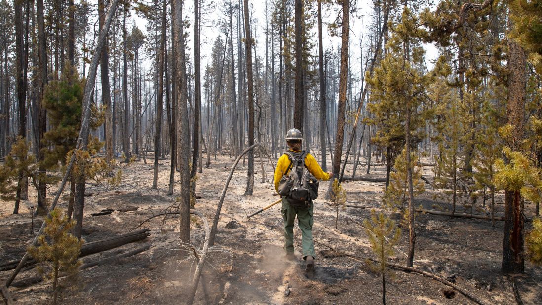 Firefighter Brentt Call walks through a burned-over area of the Bootleg Fire near Klamath Falls, Oregon, on July 27.