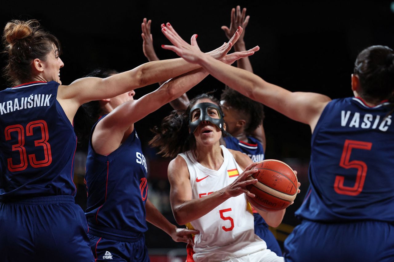 Spain's Cristina Ouviña, center, is defended by a group of Serbian players during a preliminary round basketball game on July 29.
