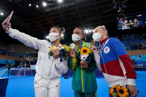 American gymnast Suni Lee takes a selfie with silver medalist Rebeca Andrade, center, and bronze medalist Angelina Melnikova after winning the individual all-around on July 29. Andrade is the first Brazilian to ever medal in women's gymnastics. Melnikova is Russian.