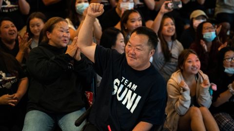 John Lee, father of US gymnast Suni Lee, celebrates his daughter's performance in the all-around.
