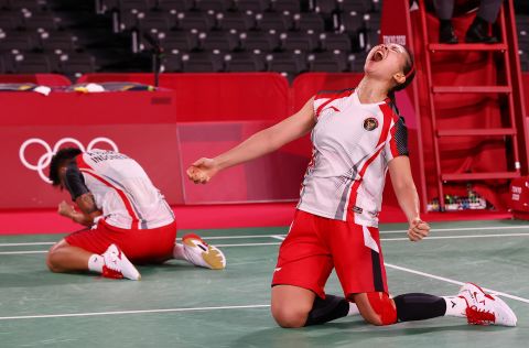 Indonesian badminton players Apriyani Rahayu and Greysia Polii react after winning their quarterfinal match on July 29.