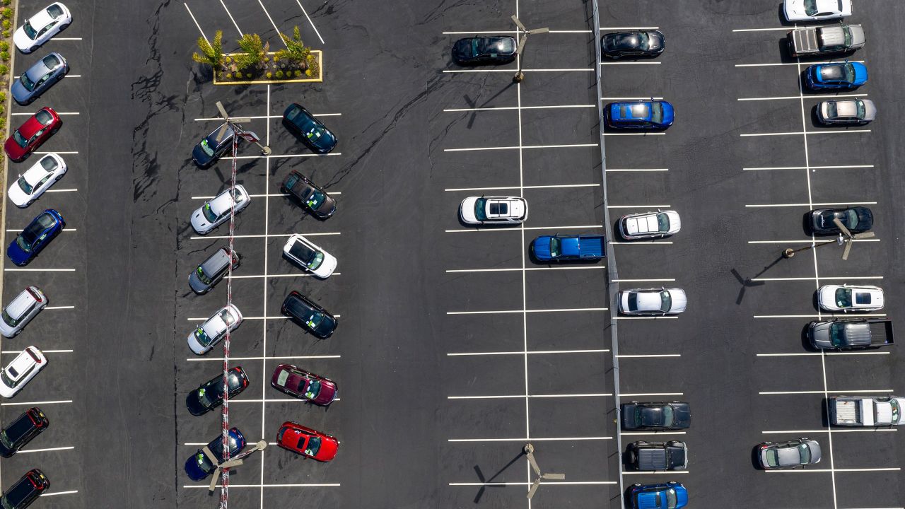 Vehicles in a nearly empty lot at a car dealership in California.