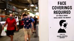 LOS ANGELES, CALIFORNIA - JULY 19: A sign is posted about required face coverings in Grand Central Market on July 19, 2021 in Los Angeles, California. A new mask mandate went into effect just before midnight on July 17th in Los Angeles County requiring all people, regardless of vaccination status, to wear a face covering in public indoor spaces amid a troubling rise in COVID-19 cases. (Photo by Mario Tama/Getty Images)
