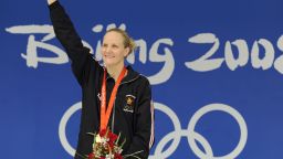 Gold medalist Zimbabwe's Kirsty Coventry stands on the podium for the women's 200m backstroke swimming final medal ceremony at the National Aquatics Center during the 2008 Beijing Olympic Games in Beijing on August 16, 2008.    Kirsty Coventry of Zimbabwe set a new world record in the women's 200 metres backstroke with a time of two minutes 05.24 seconds in the final at the Beijing Olympics. US swimmer Margaret Hoelzer placed second and Japanese swimmer Reiko Nakamura placed third.  AFP PHOTO / TIMOTHY CLARY (Photo credit should read TIMOTHY CLARY/AFP via Getty Images)