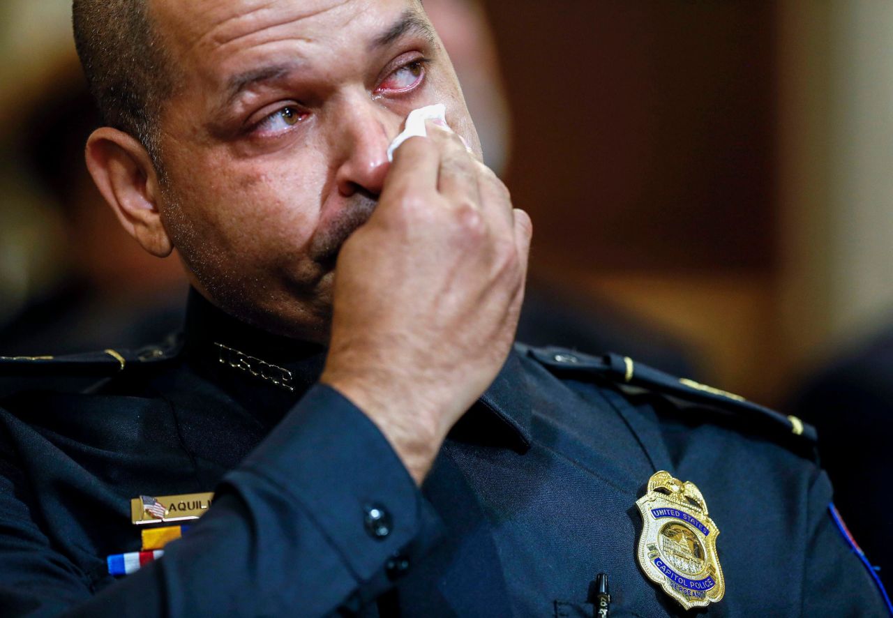 US Capitol Police Sgt. Aquilino Gonell wipes his eye Tuesday, July 27, as he watches a video about <a href="http://www.cnn.com/2021/01/06/politics/gallery/electoral-college-vote-count/index.html" target="_blank">the January 6 attack on the Capitol.</a> Gonell and three other police officers who defended the Capitol that day <a href="https://www.cnn.com/2021/07/27/politics/lingering-wounds-capitol-attacks/index.html" target="_blank">testified before a House select committee that is investigating the attack.</a> The officers made it clear that they are still dealing with physical and mental trauma from that day.