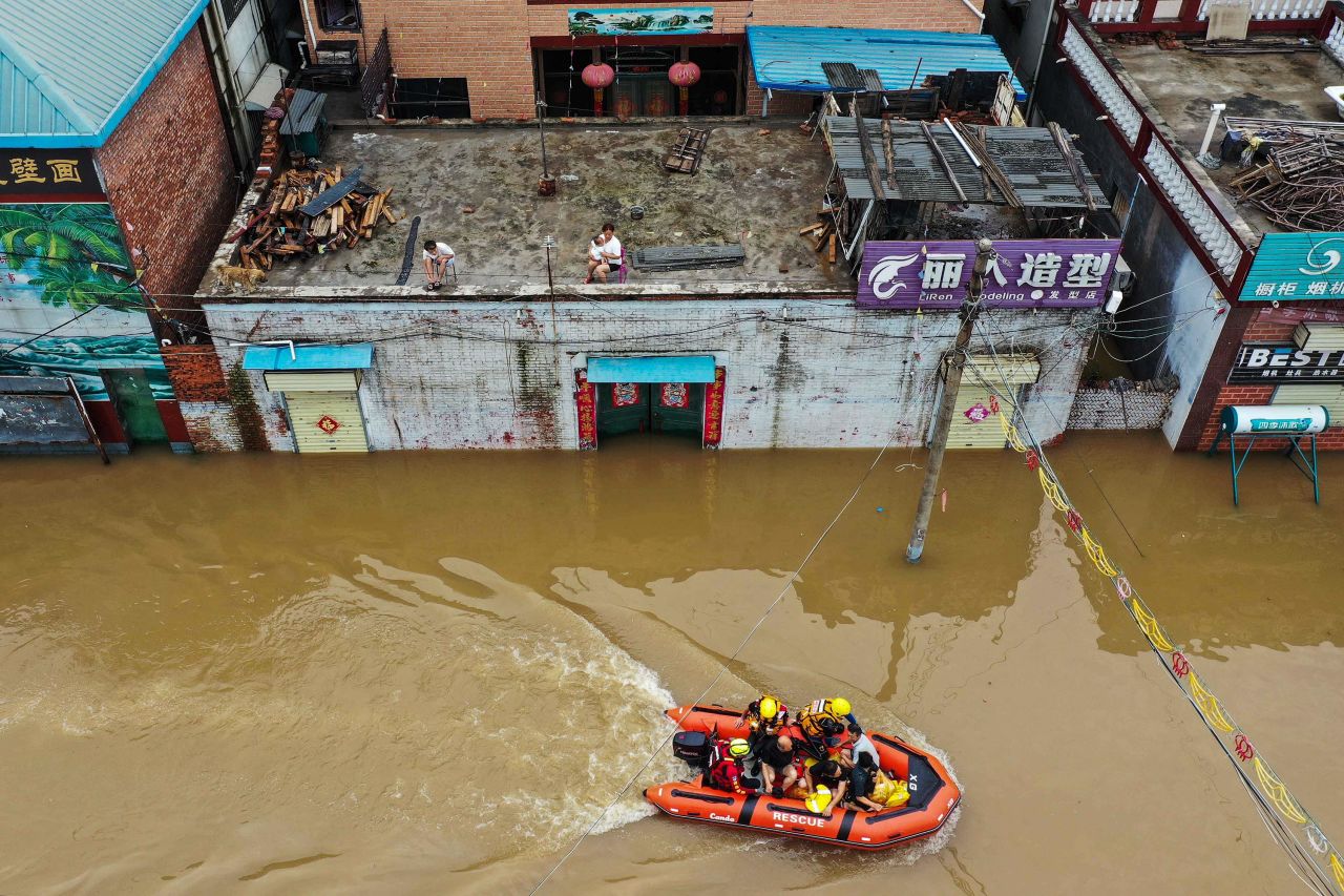 Rescue workers help residents evacuate a flooded area of Xinxiang, China, following heavy rains on Friday, July 23. <a href="https://www.cnn.com/2021/07/22/china/zhengzhou-henan-china-flooding-update-intl-hnk/index.html" target="_blank">Devastating floods</a> submerged entire neighborhoods in China's Henan province.