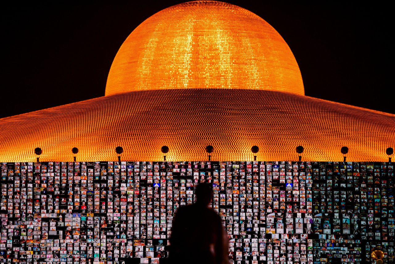 People are seen via Zoom screens Saturday, July 24, during a Buddhist Lent Day ceremony at the Wat Phra Dhammakaya temple in Thailand's Pathum Thani province.