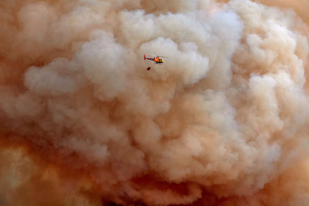 A helicopter pours water onto a forest fire Thursday, July 22, that originated in Girona, Spain. <a href="https://www.cnn.com/2021/07/27/europe/southern-europe-wildfires-sardinia-intl/index.html" target="_blank">Devastating wildfires have spread across parts of southern Europe,</a> tearing through the Spanish and Greek countryside and forcing around 1,000 people from their homes on the Italian island of Sardinia.