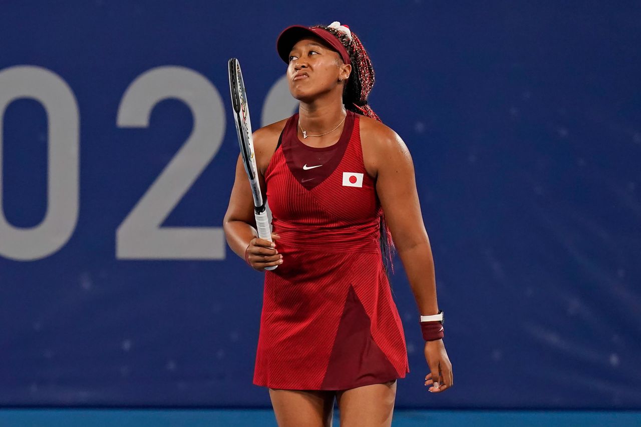 Japanese tennis star Naomi Osaka reacts during <a href="https://www.cnn.com/2021/07/27/tennis/naomi-osaka-loses-olympics-3rd-round-spt-intl/index.html" target="_blank">her Olympic loss</a> to the Czech Republic's Marketa Vondrousova on Tuesday, July 27. Osaka, who lit the Olympic cauldron during the opening ceremony, had 32 unforced errors in the third-round match. It's the first time she has lost in a hard-court tournament since the 2020 Australian Open.