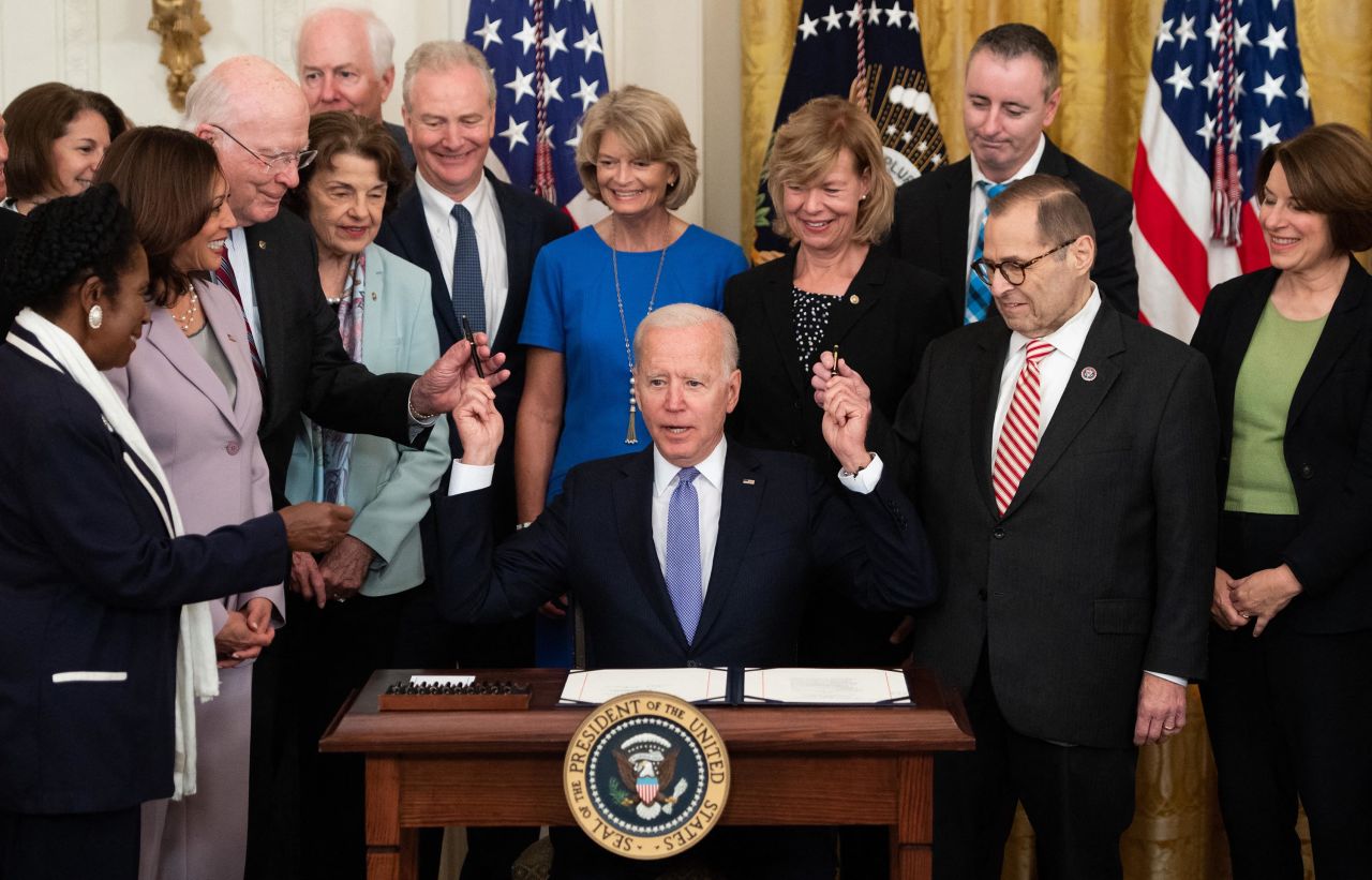 US President Joe Biden hands out pens to members of Congress on Thursday, July 22, after signing<a href="https://www.cnn.com/2021/07/22/politics/crime-victims-fund-bill-signed/index.html" target="_blank"> bipartisan legislation</a> that aims to provide assistance for crime victims, including counseling expenses, medical bills and lost wages.