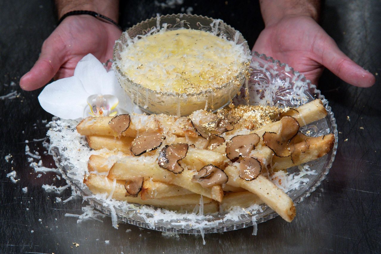 Chef Frederick Schoen-Kiewert serves the Crème de la Crème Pommes Frites, <a href="https://www.cnn.com/travel/article/serendipity-new-york-city-french-fries-intl-hnk/index.html" target="_blank">the world's most expensive french fries,</a> at the Serendipity 3 restaurant in New York on Friday, July 23. The plate costs $200.