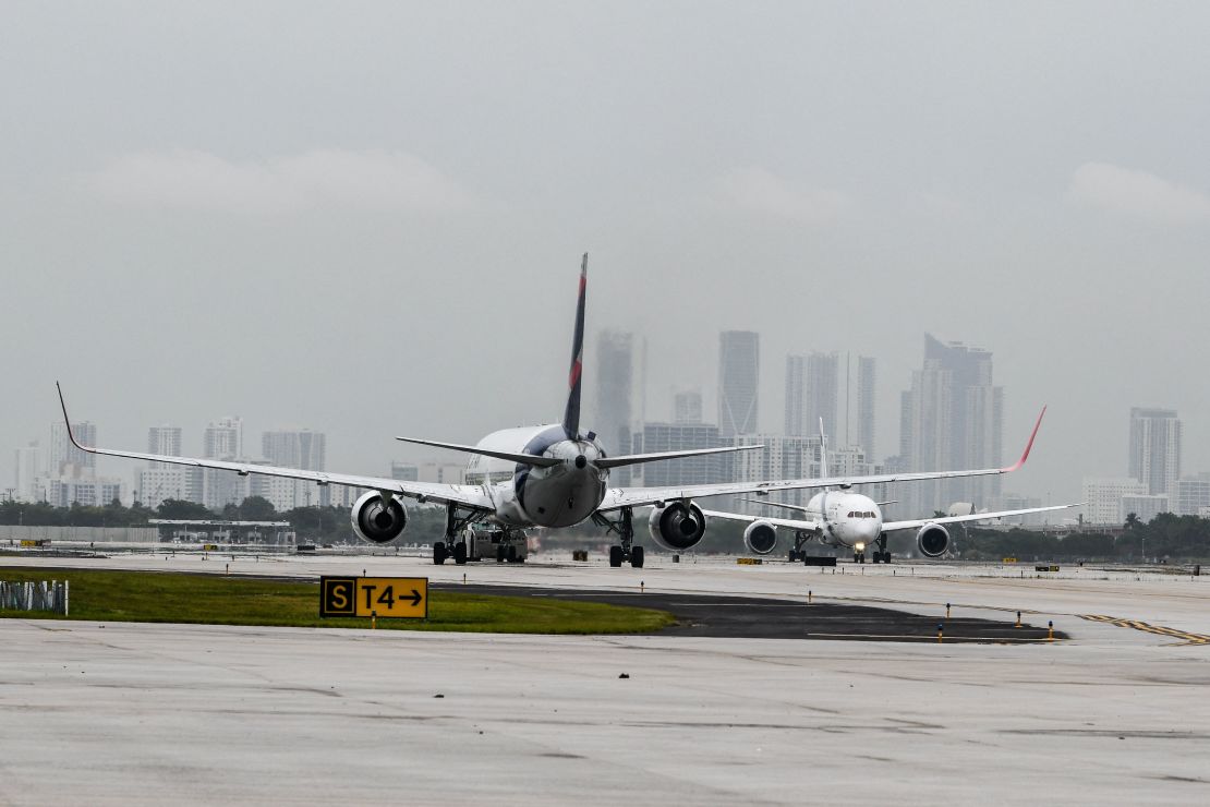 Airlines are cutting back on their flights. Here, a plane takes off at Miami International Airport.