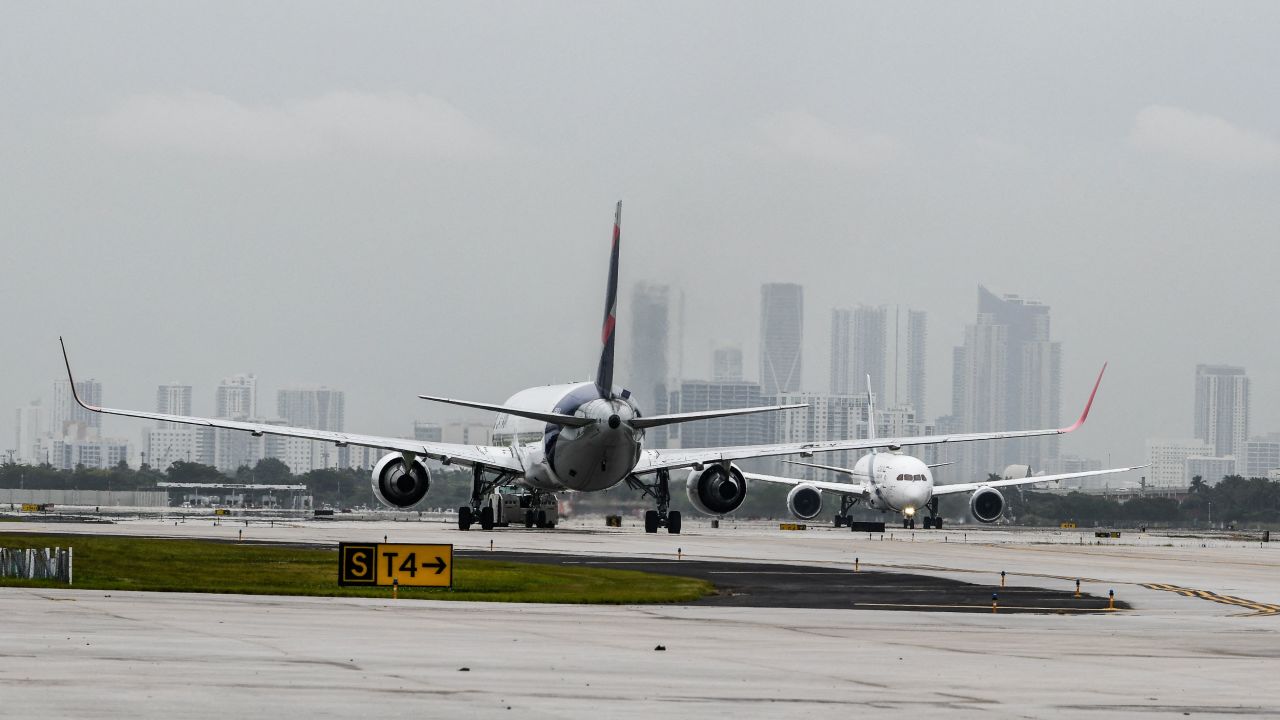 Airlines are cutting back on their flights. Here, a plane takes off at Miami International Airport.