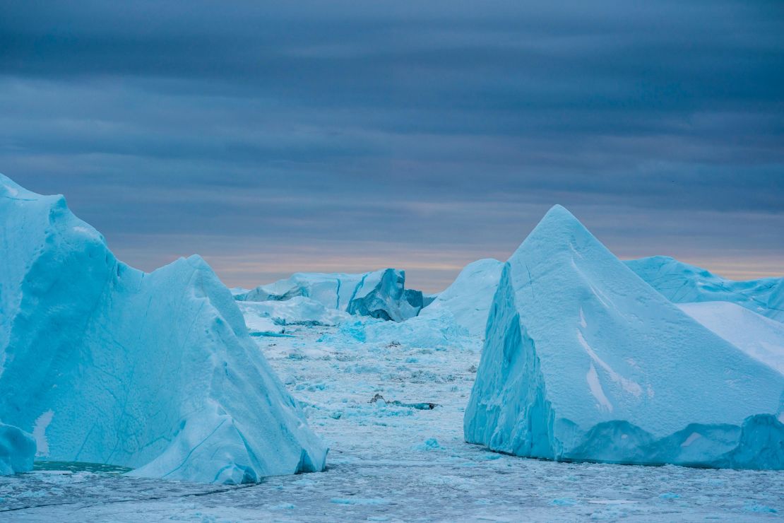 Icebergs are shown near Ilulissat, Greenland. The climate crisis is impacting the Greenland ice sheet.