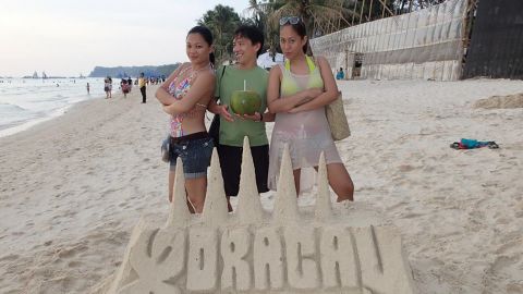 While on vacation in Boracay, Mae Edilyn Lumba Fortuna, left, and her friend Ivy, right, met American traveler Jon Takagi.