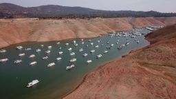 In this aerial photo houseboats sit in low water on Lake Oroville as California's drought emergency worsens, July 25, 2021 in Oroville, California. - Much of California in the western US is currently gripped  by excessive heat, severe drought and a series of massive wildfires. 