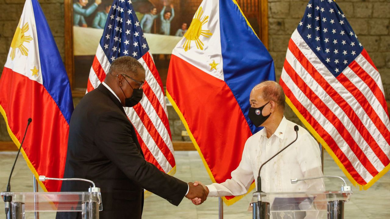 US Defense Secretary Lloyd Austin and Philippine Defense Secretary Delfin Lorenzana shake hands after a bilateral meeting at Camp Aguinaldo military base in Manila on July 30, 2021.