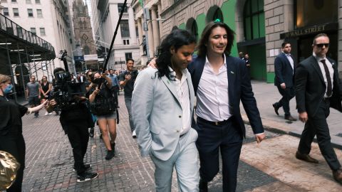 Baiju Bhatt (left) and Vlad Tenev, founders of the online brokerage Robinhood, walk along Wall Street after the company's initial public offering on July 29.