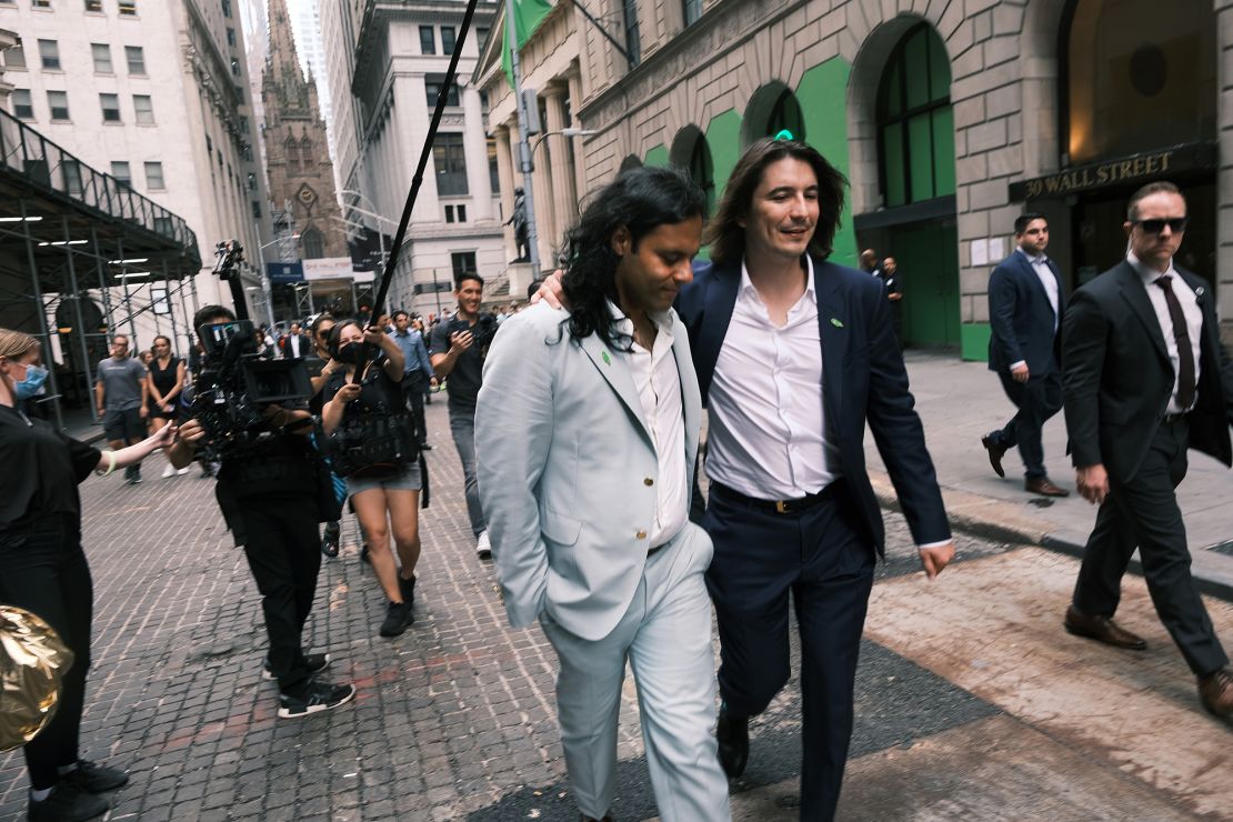 Baiju Bhatt (left) and Vlad Tenev, founders of the online brokerage Robinhood, walk along Wall Street after the company's initial public offering on July 29.