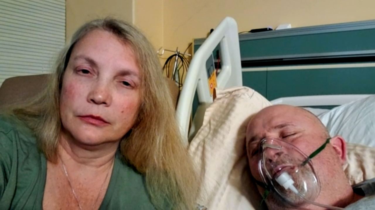 Alicia Ball sits beside her husband, William, in a Mississippi hospital battling Covid-19.