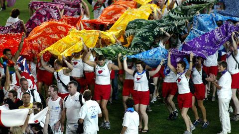 Participants from the United Kingdom team march onto the field during the opening ceremony of the 2002 Gay Games in Sydney, Australia.