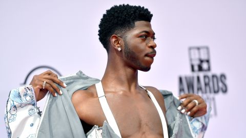 Lil Nas X, seen posing on the red carpet of the BET Awards, is committed to being himself, which could make the music industry a more accepting place for LGBTQ artists, academics told CNN.