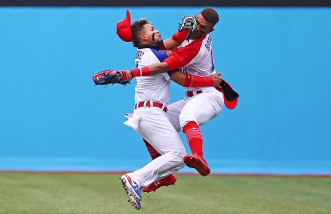 Dominican baseball players Gustavo Nunez, left, and Julio Rodriguez collide as Rodriguez catches a ball during their 1-0 win over Mexico on July 30.