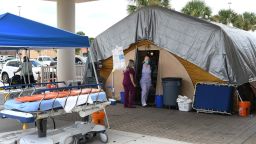 MELBOURNE, FLORIDA, UNITED STATES - 2021/07/29: Nurses are seen at a treatment tent outside the emergency department at Holmes Regional Medical Center in Melbourne.
 The tent was set up to serve as an overflow area as the number of COVID-19 infections surges throughout Brevard County, Florida due to the Delta variant and large numbers of unvaccinated residents. (Photo by Paul Hennessy/SOPA Images/LightRocket via Getty Images)
