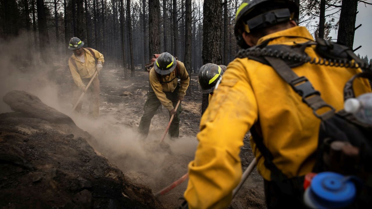 Firefighters from New Mexico work amidst heavy ash and dust to help contain the Bootleg Fire near Silver Lake, Oregon, on July 29, 2021.