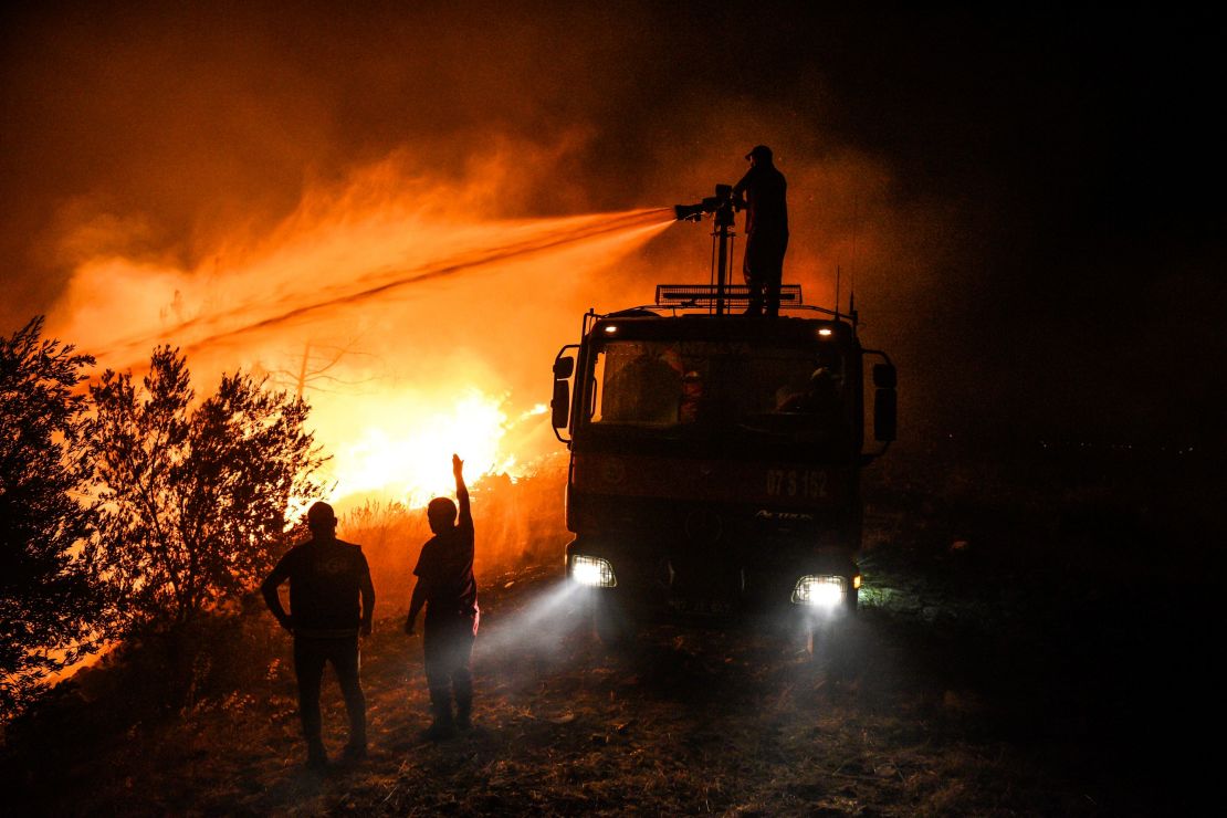Firefighters try to get the fire under control in Kirli village near the town of Manavgat, in Antalya province, early Friday July 30.