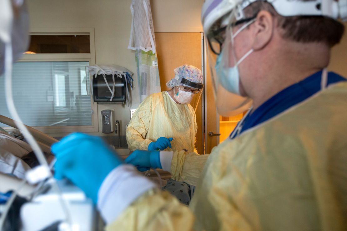 Health care workers assist a patient in the ICU inside Little Company of Mary Medical Center on July 30, 2021 in Torrance, California 