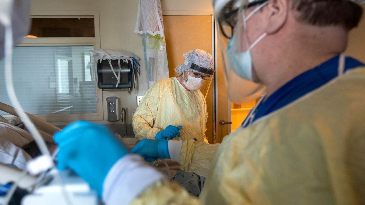 Health care workers assist a patient in the ICU inside Little Company of Mary Medical Center on July 30, 2021 in Torrance, California 