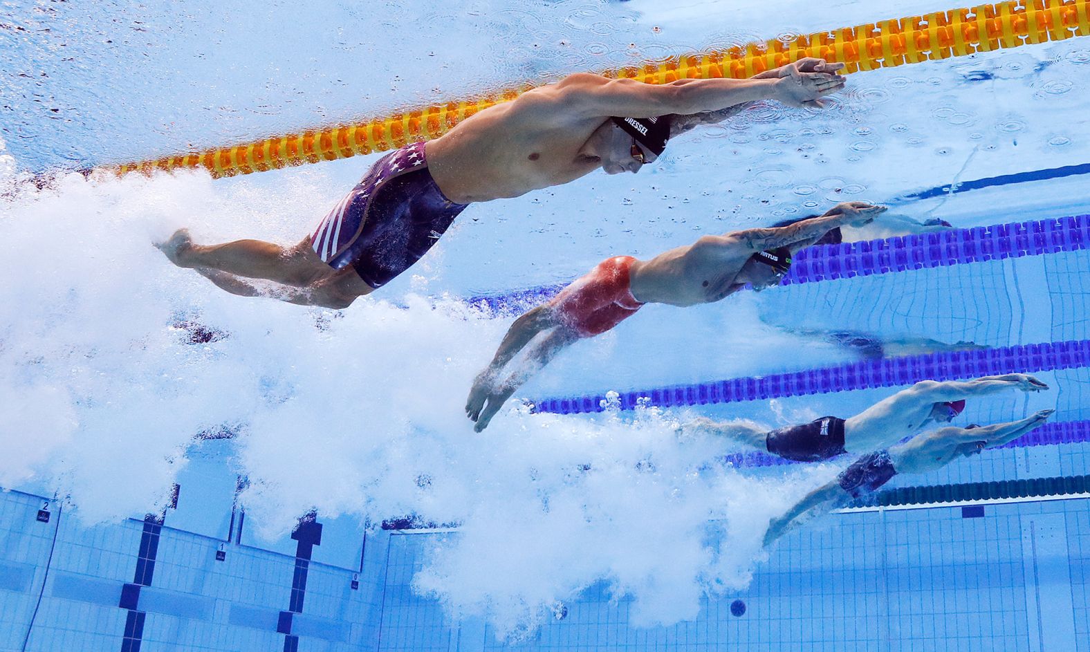 From left, the United States' Caeleb Dressel, Brazil's Bruno Fratus, Great Britain's Benjamin Proud and Italy's Lorenzo Zazzeri swim the 50-meter freestyle final on August 1. <a href="index.php?page=&url=https%3A%2F%2Fwww.cnn.com%2Fworld%2Flive-news%2Ftokyo-2020-olympics-07-31-21-spt%2Fh_c226c17ea9aa7f2579e8e24284aa494f" target="_blank">Dressel went on to win</a> with an Olympic record time of 21.07 seconds. He won five golds in Tokyo.