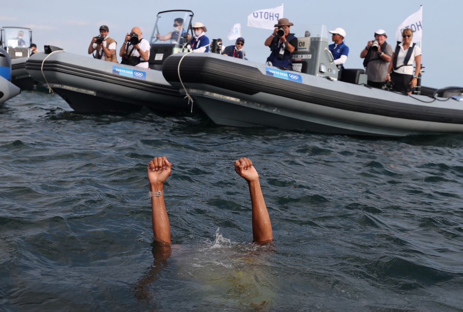 Dutch sailor Kiran Badloe jumps into the water to celebrate after winning gold in the men's RS:X category on August 1.