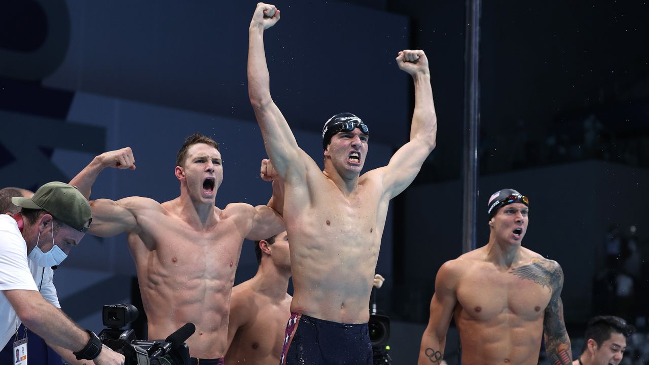 Ryan Murphy (from left), Zach Apple and Caeleb Dressel of Team United States react after winning the gold medal and breaking the world record in the Men's 4x100m Medley Relay Final on Sunday.