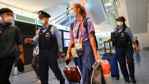 Kristina Timanovskaya is escorted by police officers at Haneda international airport in Tokyo, Japan on Sunday August 1.